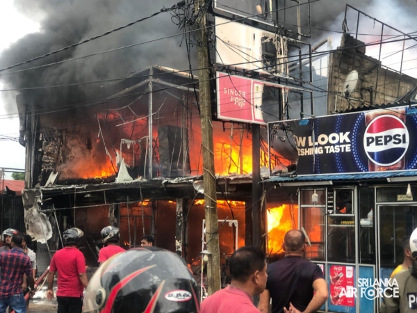 SLAF ASSISTS IN EXTINGUISHING FIRE AT SINGER SHOWROOM IN VAVUNIYA